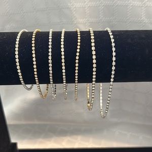 Costume tennis bracelets.  7 bracelets in both silver and gold tones.